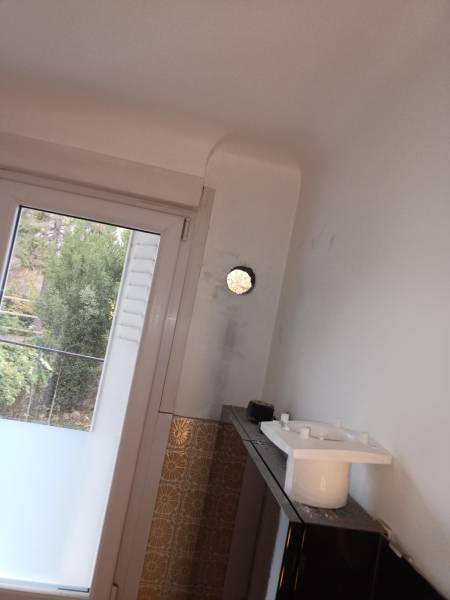 Réalisation d'un carottage dans le mur d'enceinte pour la pose d'un aérateur permanent